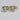Gold earrings with large clear gemstones on a light gray background