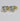 Gold earrings with large clear gemstones on a light gray background